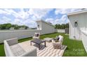 Inviting rooftop deck featuring stylish outdoor seating and artificial turf for a relaxing atmosphere at 5007 Nimes Rd # 28, Charlotte, NC 28208