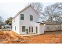 Rear view of a new construction home featuring white siding and an open back patio at 504 Sharpe St, Mooresville, NC 28115