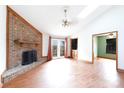 Bright living room featuring a brick fireplace, hardwood floors, and glass doors at 5060 Post Oak Ln, Rock Hill, SC 29732