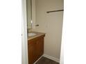 Half bathroom with modern fixtures, a decorative mirror, and an oak-trimmed vanity at 6354 Old Pineville Rd # A, Charlotte, NC 28217