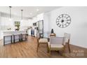 Modern kitchen with stainless steel appliances, quartz countertops, and a cozy dining area at 8455 Old Plank Rd, Charlotte, NC 28216