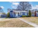 Charming blue single-story home with a manicured lawn, white trim, and an American flag at 1205 Poston Cir, Gastonia, NC 28054