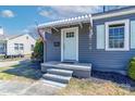 Charming front porch with a light blue door, white awning, and neat landscaping at 1205 Poston Cir, Gastonia, NC 28054