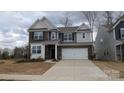 Charming two-story home featuring a brick and siding facade with an attached two-car garage at 14705 Superior St, Charlotte, NC 28273