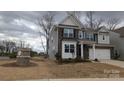 Attractive two-story home featuring a mixed facade, well-manicured lawn, and a two-car garage at 14705 Superior St, Charlotte, NC 28273