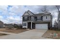 Attractive two-story home featuring a mixed facade, well-manicured lawn, and a two-car garage at 14705 Superior St, Charlotte, NC 28273