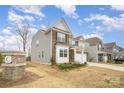 Two-story home with brick and gray siding, a two-car garage, front yard and brick column feature at 14705 Superior St, Charlotte, NC 28273