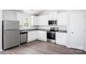 Bright kitchen featuring white cabinets, stainless steel appliances, and gray countertops at 1568 Doran Ter, Richburg, SC 29729