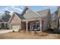 Beautiful brick home featuring a cozy front porch with seating, complemented by a well-maintained lawn at 1715 Rhynes Trl, Rock Hill, SC 29732