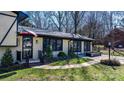 Charming home featuring a brick facade, black trim, and landscaped front yard, creating an inviting curb appeal at 2530 31St Street Ne Dr, Hickory, NC 28601