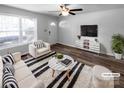 Bright living room featuring hardwood floors, a ceiling fan, and natural light from the front door at 2725 Fair Oaks Dr, Gastonia, NC 28054