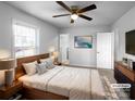 Tranquil bedroom featuring a ceiling fan, modern decor, and an ensuite bathroom at 2725 Fair Oaks Dr, Gastonia, NC 28054