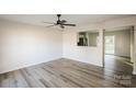 Bright and spacious living room with new floors, modern ceiling fan, and an open floor plan at 2868 Oasis Ln, Charlotte, NC 28214