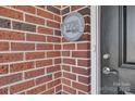 Close-up of a brick wall with the '1776 Community' plaque and the front door at 3069 Founding Fathers Dr # 38, Gastonia, NC 28056