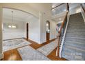 Open foyer showcasing hardwood floors, staircase, and elegant archways create a welcoming atmosphere at 423 Castlebury Ct, Clover, SC 29710