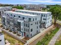 Contemporary townhomes boast clean lines, multiple windows, and a perimeter fence for privacy and security at 5003 Tiny Ln, Charlotte, NC 28203