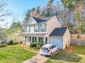 Attractive two-story home with a front-facing garage, features a well-maintained lawn at 5414 Peachwood Dr, Charlotte, NC 28216