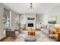 Bright living room with fireplace, custom bookshelves, and large windows at 6141 Creft Cir, Indian Trail, NC 28079