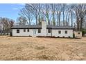 Charming single-story home with brick exterior, light blue front door, mature trees, and well-maintained lawn at 6301 Vernedale Rd, Charlotte, NC 28212