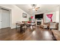 Comfortable living room featuring a fireplace, hardwood floors, and a ceiling fan at 6708 Burning Oak Ln, Charlotte, NC 28216