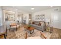 Bright living room featuring modern furniture, neutral color palette, and wood-look floors at 8573 River Ridge Dr, Charlotte, NC 28213