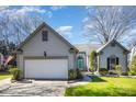 Charming home with a well-manicured lawn, two car garage, and a blue front door at 9200 Four Acre Ct, Charlotte, NC 28210