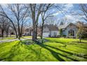 Beautifully landscaped front yard with mature trees that complements the exterior of the house at 9200 Four Acre Ct, Charlotte, NC 28210