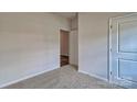 Bedroom with neutral carpet and doorway leading to closet at 9534 Maltese Dr, Gastonia, NC 28056