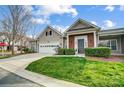 Well-maintained home with a manicured lawn, brick detail, and an attached two-car garage at 10011 Forest View Ln, Charlotte, NC 28213