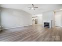 Living room featuring hardwood floors, a fireplace, and an open concept design leading to the kitchen at 10011 Forest View Ln, Charlotte, NC 28213