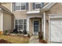 Inviting front entrance with well manicured lawn, walkway, seating area and a view of the garage and house number at 11712 Huxley Rd, Charlotte, NC 28277