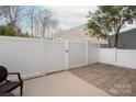 Private patio with white fence offering an ideal space for outdoor relaxation at 1915 Colony Line Ct, Charlotte, NC 28210