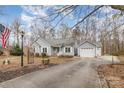 Lovely single-story home with detached garage, well-maintained yard, and a decorative lamp post at 207 Cypress Dr, Gastonia, NC 28052