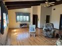 Living room with hardwood floors, high ceilings with exposed beams, and natural light at 2211 Unionville Indian Trl, Indian Trail, NC 28079