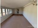 Enclosed sun room featuring carpeted flooring and an abundance of natural light at 2211 Unionville Indian Trl, Indian Trail, NC 28079