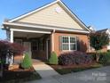 Charming brick home with a covered porch, complemented by mature landscaping and inviting curb appeal at 2227 Cashmere Ct, Denver, NC 28037