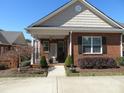 Charming brick home with a covered porch and beautifully landscaped front yard at 2227 Cashmere Ct, Denver, NC 28037