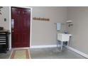 Garage area with a utility sink, tool chest, and coat rack by the door at 2227 Cashmere Ct, Denver, NC 28037