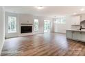 Open-concept living room featuring a modern fireplace, wood flooring, and a seamless transition to the kitchen area at 2228 Tabor Rd # 569, Sherrills Ford, NC 28673