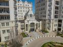 Aerial view showcasing the building's architectural design and the landscaped circular driveway of this elegant condo at 2823 Providence Rd # 236, Charlotte, NC 28211