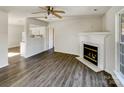 Open floor plan view of living room with fireplace leading to kitchen at 3212 Irwin Valley Ct, Charlotte, NC 28269