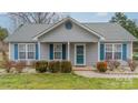 Inviting home featuring blue shutters, a covered porch, and well-manicured landscaping at 3414 Clearview Dr, Monroe, NC 28110