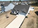 Aerial view of a single-story home with a two-car garage and landscaping, nestled in a peaceful neighborhood at 358 Caffee Dr, Kings Mountain, NC 28086