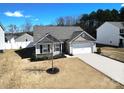 Well-maintained single-story home featuring a two-car garage and landscaping, showcasing a welcoming facade at 358 Caffee Dr, Kings Mountain, NC 28086