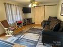 Inviting living room featuring a rustic barn door and comfortable seating at 410 Yadkin St, Salisbury, NC 28146