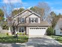 Attractive two-story home features a two-car garage, basketball hoop, and beautifully landscaped front yard at 421 Silver Cypress Ln, Fort Mill, SC 29708