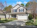 Charming home featuring a two-car garage, manicured lawn, and inviting front porch at 421 Silver Cypress Ln, Fort Mill, SC 29708