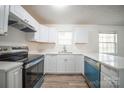 Bright kitchen features white cabinets, modern countertops, and stainless steel appliances for a clean, updated look at 4910 Lailwood Cir, Charlotte, NC 28227