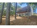 Two story house with a covered porch, gray siding, and a tiered landscaped yard at 604 Fairway Shores Rd, Mount Gilead, NC 27306