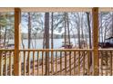 Breathtaking view from the deck overlooking the tranquil lake, framed by lush trees creating a peaceful retreat at 604 Fairway Shores Rd, Mount Gilead, NC 27306